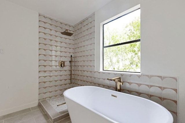 13265 Kerrville Folkway Dr, Austin, TX 78729 - bathroom featuring tile patterned flooring, a walk in shower, a freestanding tub, and tile walls