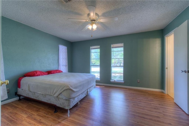 1811 Lone Oak Dr, Leander, TX 78641 - bedroom featuring wood finished floors, a textured ceiling, and ceiling fan