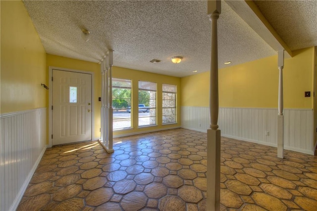 1811 Lone Oak Dr, Leander, TX 78641 - foyer with wainscoting and a textured ceiling