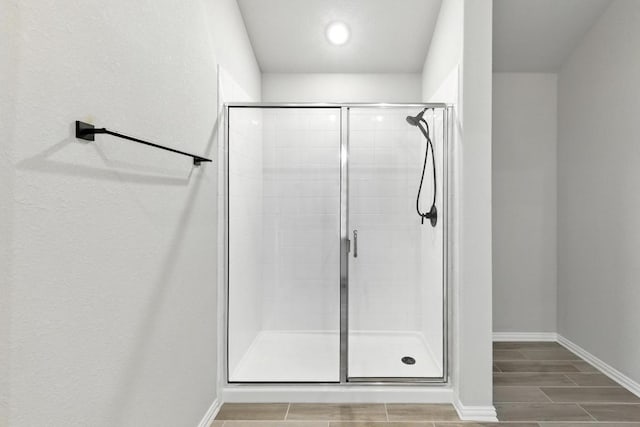 149 Hackberry Ln, Bastrop, TX 78602 - full bathroom featuring a stall shower, wood finish floors, and recessed lighting