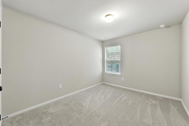 149 Hackberry Ln, Bastrop, TX 78602 - unfurnished room with carpet flooring, a textured ceiling, and a smoke detector