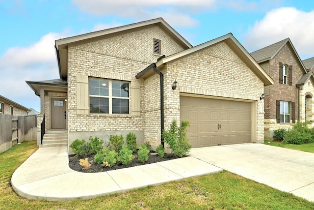 149 Hackberry Ln, Bastrop, TX 78602 - view of front of house with brick siding, an attached garage, and concrete driveway
