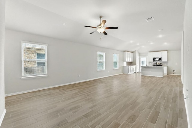149 Hackberry Ln, Bastrop, TX 78602 - unfurnished living room with a ceiling fan, vaulted ceiling, and light wood-type flooring