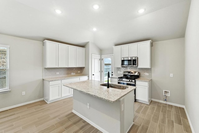 149 Hackberry Ln, Bastrop, TX 78602 - kitchen featuring appliances with stainless steel finishes, light wood finished floors, tasteful backsplash, lofted ceiling, and recessed lighting