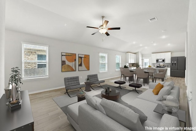 149 Hackberry Ln, Bastrop, TX 78602 - living room with vaulted ceiling, light wood-style flooring, and a ceiling fan