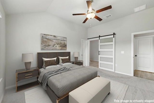 149 Hackberry Ln, Bastrop, TX 78602 - carpeted bedroom with a barn door, vaulted ceiling, and a ceiling fan
