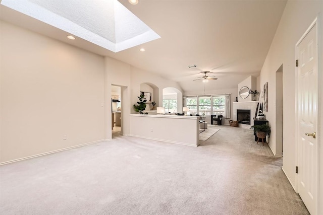 1108 Red Ranch Cir, Cedar Park, TX 78613 - living area with light colored carpet, a fireplace, a skylight, a ceiling fan, and recessed lighting
