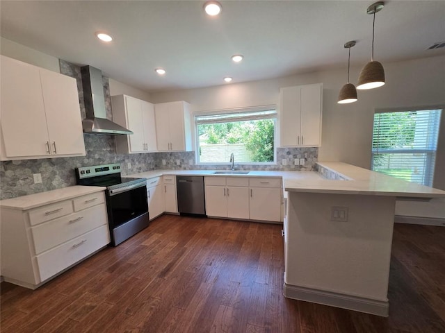 2105 Tiger Trl Unit 702, Round Rock, TX 78664 - kitchen with wall chimney exhaust hood, stainless steel appliances, a peninsula, light countertops, and tasteful backsplash
