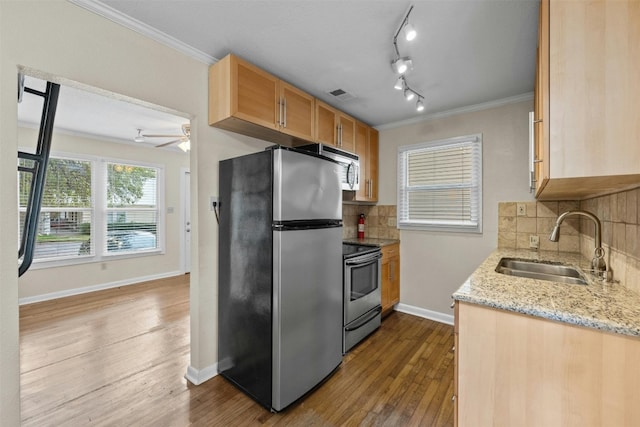1110 W 22nd St Unit 1, Austin, TX 78705 - kitchen featuring stainless steel appliances, ornamental molding, light stone counters, dark wood-type flooring, and decorative backsplash