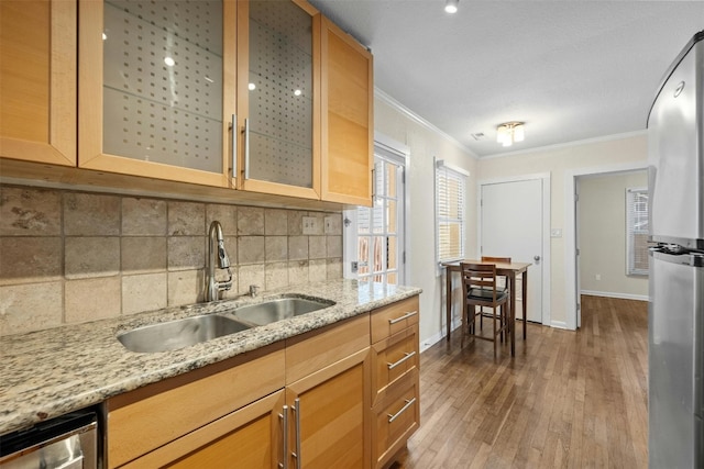 1110 W 22nd St Unit 1, Austin, TX 78705 - kitchen with ornamental molding, dark wood-type flooring, decorative backsplash, light stone counters, and glass insert cabinets