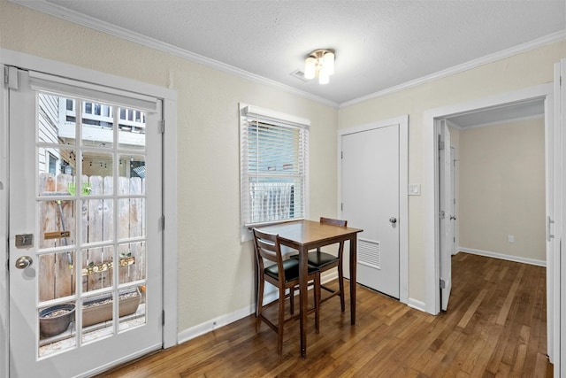 1110 W 22nd St Unit 1, Austin, TX 78705 - dining area featuring wood finished floors, ornamental molding, and a textured ceiling