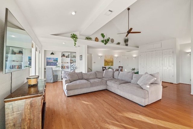 8132 Breeze Way, Jonestown, TX 78645 - living area with a ceiling fan, wood finished floors, and high vaulted ceiling
