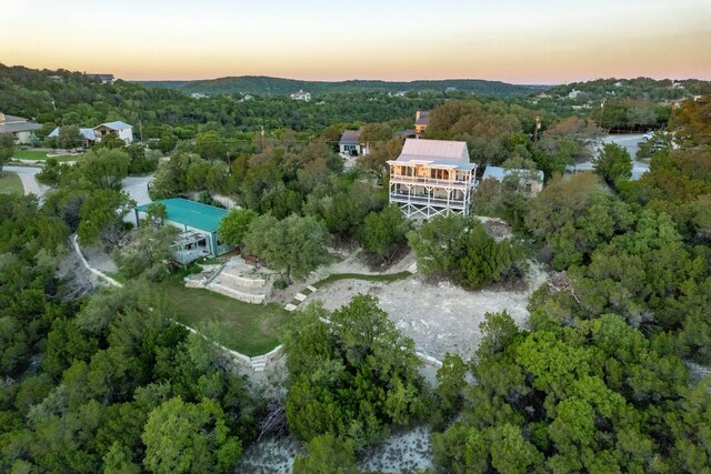 8132 Breeze Way, Jonestown, TX 78645 - aerial view at dusk of a wooded view