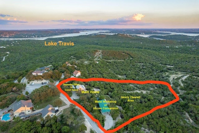 8132 Breeze Way, Jonestown, TX 78645 - aerial view at dusk of property parcel outlined and a wooded view