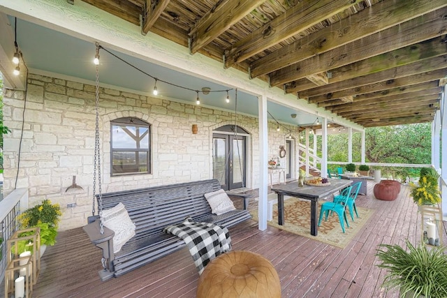 8132 Breeze Way, Jonestown, TX 78645 - wooden terrace with outdoor dining space and french doors