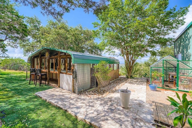 8132 Breeze Way, Jonestown, TX 78645 - view of greenhouse with a lawn