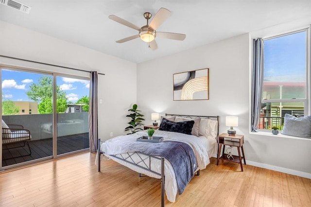 5325 Sendero Hills Pkwy, Austin, TX 78724 - bedroom with multiple windows, access to outside, wood finished floors, and ceiling fan