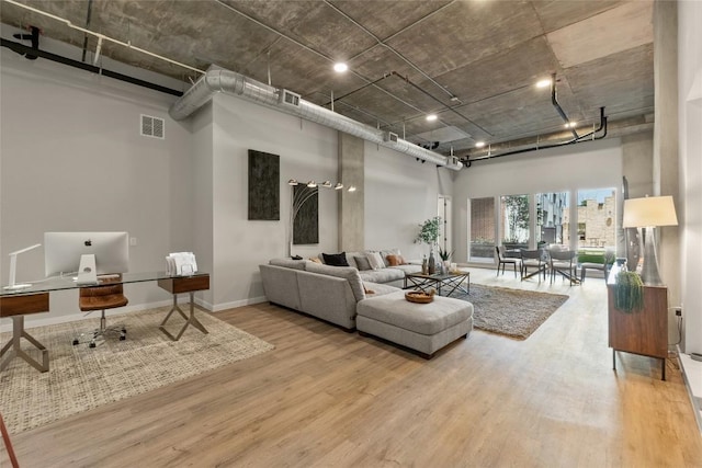 4510 Terry-O Ln Unit 126, Austin, TX 78745 - living area with a high ceiling, wood finished floors, and a desk