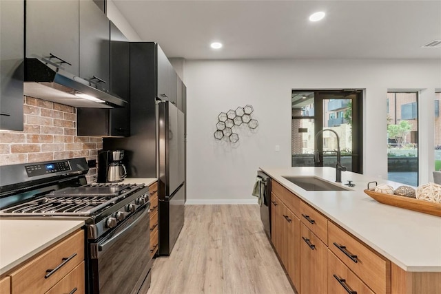 4510 Terry-O Ln Unit 126, Austin, TX 78745 - kitchen with gas stove, under cabinet range hood, light wood finished floors, freestanding refrigerator, and backsplash