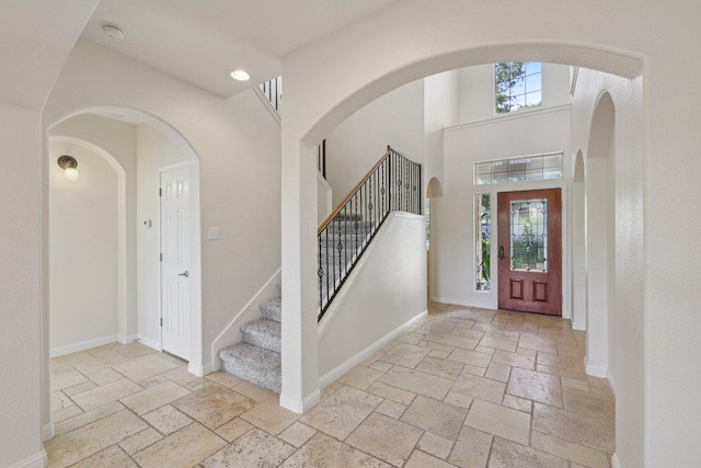 11421 Dona Villa Dr, Austin, TX 78726 - entrance foyer with stone tile flooring, healthy amount of natural light, stairway, and a high ceiling