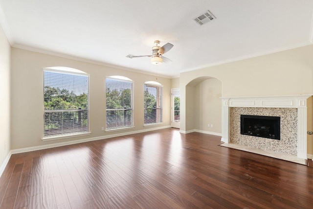 11421 Dona Villa Dr, Austin, TX 78726 - unfurnished living room with plenty of natural light, a ceiling fan, ornamental molding, dark wood finished floors, and a tile fireplace