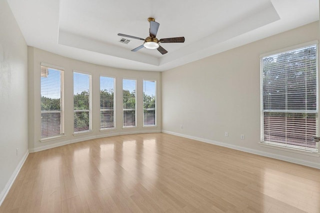 11421 Dona Villa Dr, Austin, TX 78726 - unfurnished room with a raised ceiling, light wood finished floors, and ceiling fan