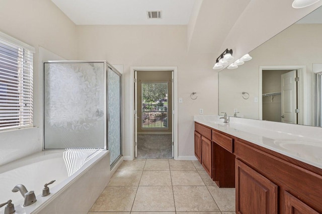 11421 Dona Villa Dr, Austin, TX 78726 - full bathroom featuring a stall shower, double vanity, tile patterned flooring, a garden tub, and a spacious closet