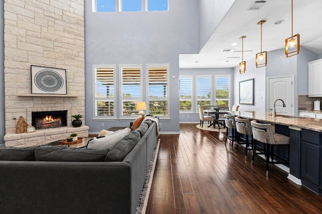 1702 Ambling Trl, Cedar Park, TX 78613 - living room with a high ceiling, dark wood-type flooring, and a stone fireplace
