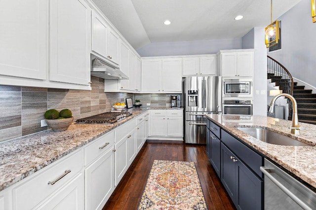 1702 Ambling Trl, Cedar Park, TX 78613 - kitchen with stainless steel appliances, white cabinetry, dark wood-style floors, under cabinet range hood, and decorative backsplash