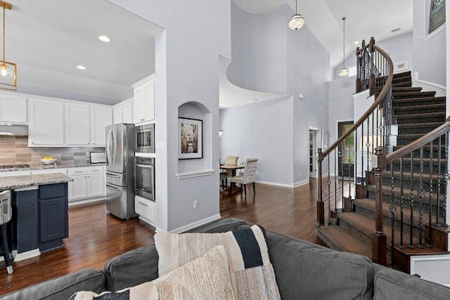 1702 Ambling Trl, Cedar Park, TX 78613 - living area featuring dark wood-style flooring, stairway, a high ceiling, and recessed lighting