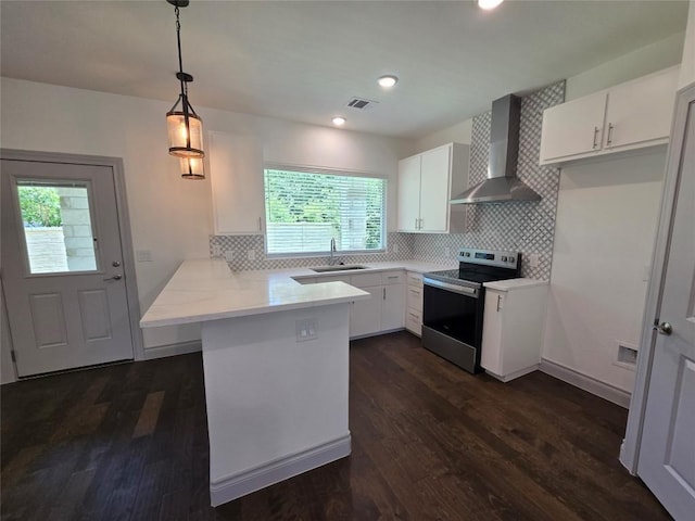2105 Tiger Trl Unit 701, Round Rock, TX 78664 - kitchen with wall chimney exhaust hood, stainless steel electric range oven, a peninsula, white cabinets, and light countertops