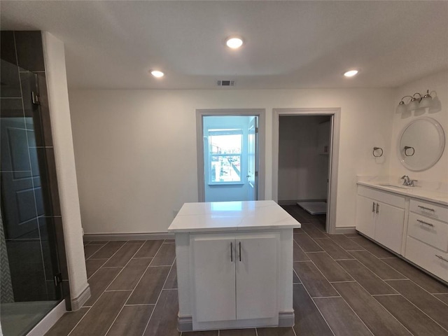 2105 Tiger Trl Unit 701, Round Rock, TX 78664 - kitchen with white cabinetry, light countertops, recessed lighting, and a kitchen island