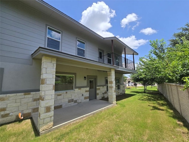 2105 Tiger Trl Unit 701, Round Rock, TX 78664 - back of house featuring a balcony, stone siding, and a patio area