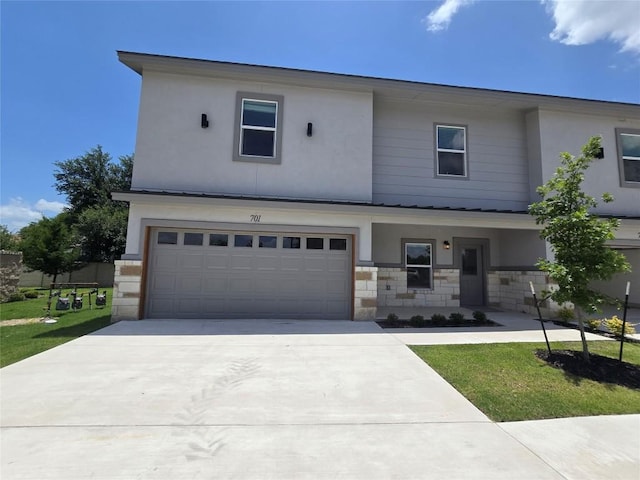 2105 Tiger Trl Unit 701, Round Rock, TX 78664 - view of front of property featuring an attached garage, driveway, stone siding, and stucco siding