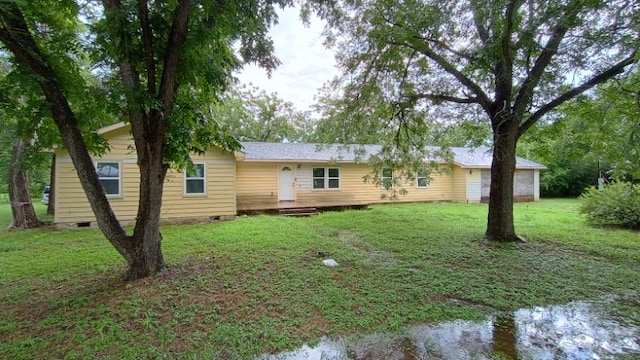 112 W Ila St, Elgin, TX 78621 - back of property with crawl space, a yard, and a deck