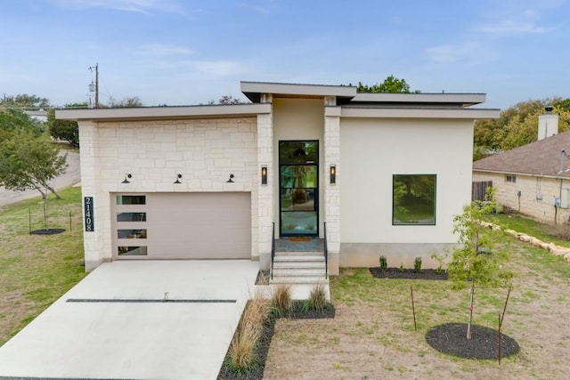21408 Lakefront Dr, Lago Vista, TX 78645 - contemporary home with concrete driveway, stucco siding, stone siding, and a front lawn