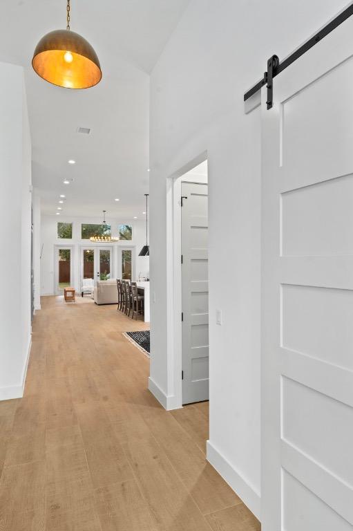 21408 Lakefront Dr, Lago Vista, TX 78645 - hallway featuring a barn door and recessed lighting