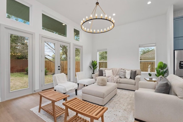 21408 Lakefront Dr, Lago Vista, TX 78645 - living area with french doors, a high ceiling, recessed lighting, a chandelier, and light wood finished floors