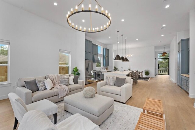 21408 Lakefront Dr, Lago Vista, TX 78645 - living room with healthy amount of natural light, recessed lighting, a chandelier, and light wood-style floors