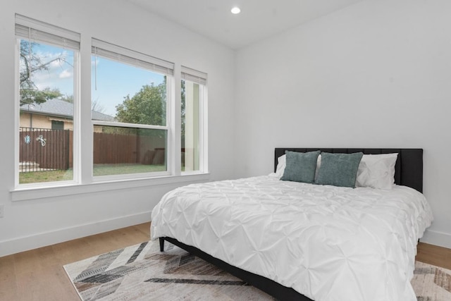 21408 Lakefront Dr, Lago Vista, TX 78645 - bedroom featuring multiple windows, wood finished floors, and recessed lighting