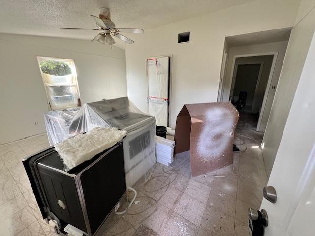 908 Glass Dr, Leander, TX 78641 - kitchen featuring a ceiling fan and a textured ceiling