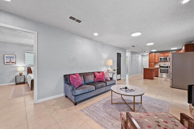 8 Spalding Cir, Wimberley, TX 78676 - living area featuring a textured ceiling, light tile patterned flooring, and recessed lighting