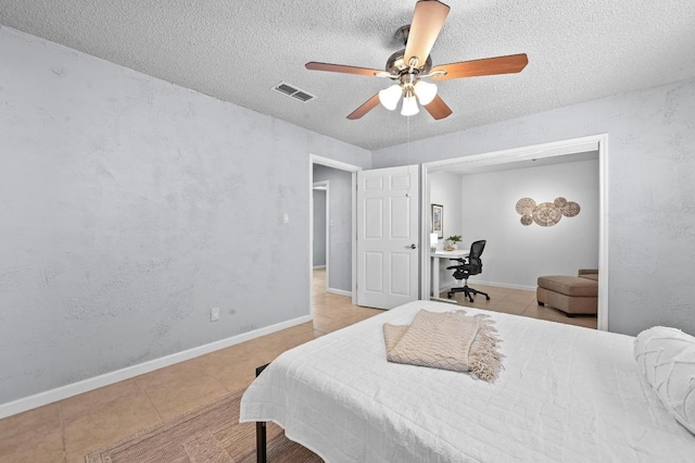 8 Spalding Cir, Wimberley, TX 78676 - bedroom featuring light tile patterned floors, a textured ceiling, and a ceiling fan