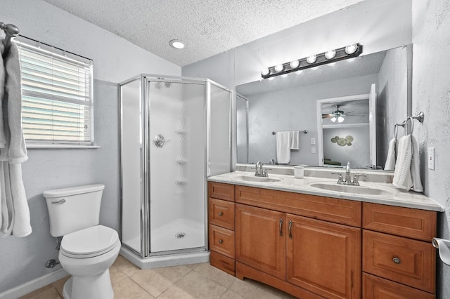 8 Spalding Cir, Wimberley, TX 78676 - full bathroom featuring a textured ceiling, tile patterned flooring, a stall shower, a ceiling fan, and double vanity