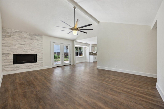 2701 Coatbridge Dr, Austin, TX 78745 - unfurnished living room featuring ceiling fan, dark wood-type flooring, a stone fireplace, and french doors