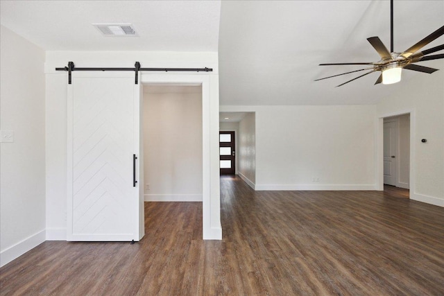 2701 Coatbridge Dr, Austin, TX 78745 - unfurnished room with a barn door, wood finished floors, and ceiling fan
