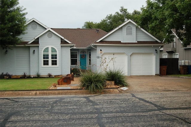 12615 Dove Valley Trl, Austin, TX 78729 - ranch-style home featuring concrete driveway, a garage, brick siding, a front lawn, and roof with shingles