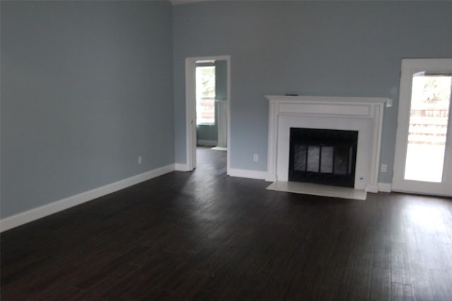 12615 Dove Valley Trl, Austin, TX 78729 - unfurnished living room with dark wood-style floors and a fireplace with flush hearth