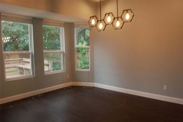12615 Dove Valley Trl, Austin, TX 78729 - unfurnished room featuring dark wood-style flooring and a chandelier
