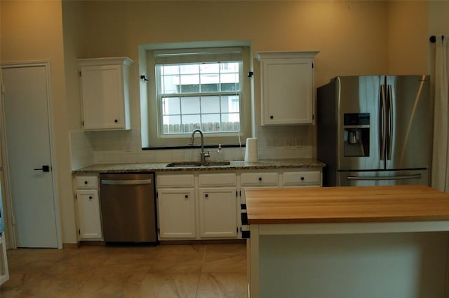 12615 Dove Valley Trl, Austin, TX 78729 - kitchen with stainless steel appliances, decorative backsplash, and white cabinetry